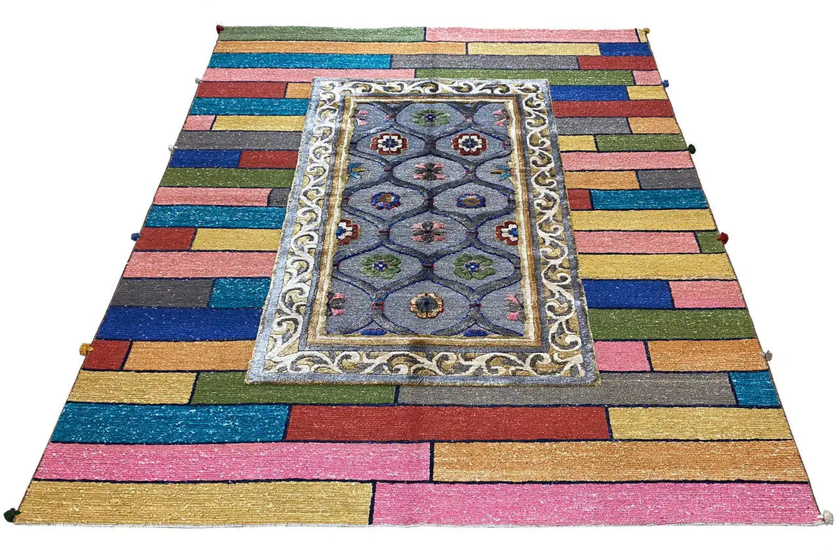 Colorful patterned rug with a rectangular medallion and ornamental border