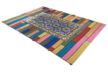 Corner view: colorful rug with a central medallion and decorative border