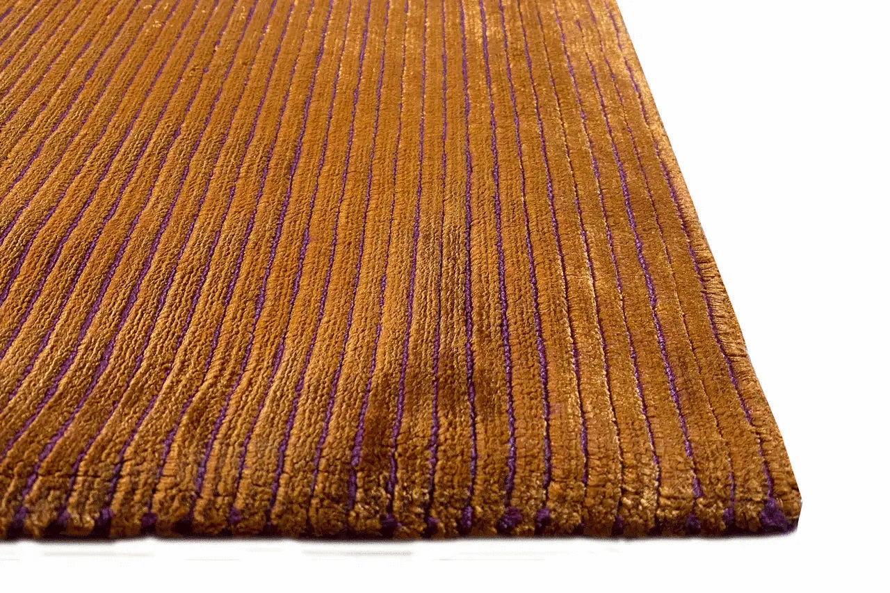 Designer rug Cecile: yellowish-brown pile with densely edged purple longitudinal stripes.