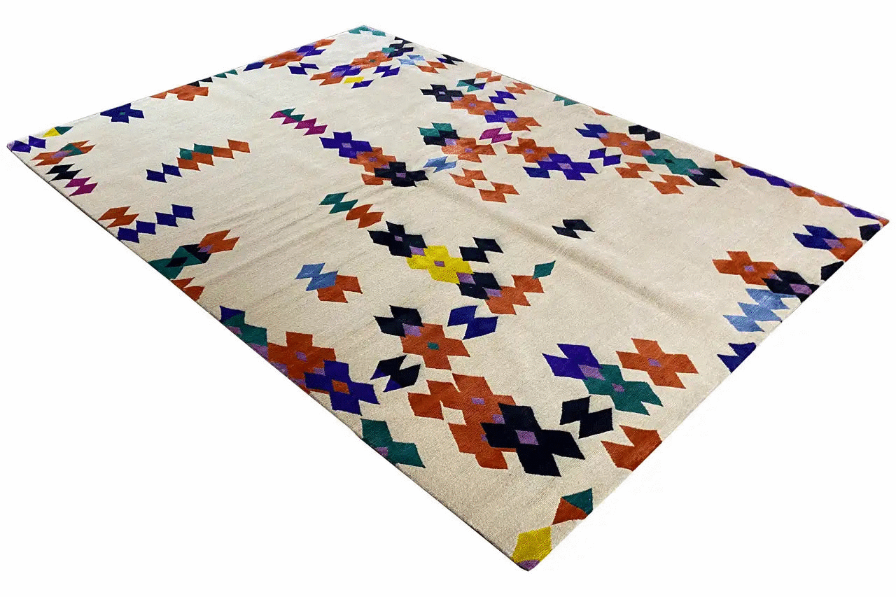Carpet with a geometric pattern in blue, red, green, and violet on a light background, corner view.