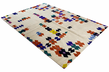 Carpet with a geometric pattern in blue, red, green, and violet on a light background, corner view.