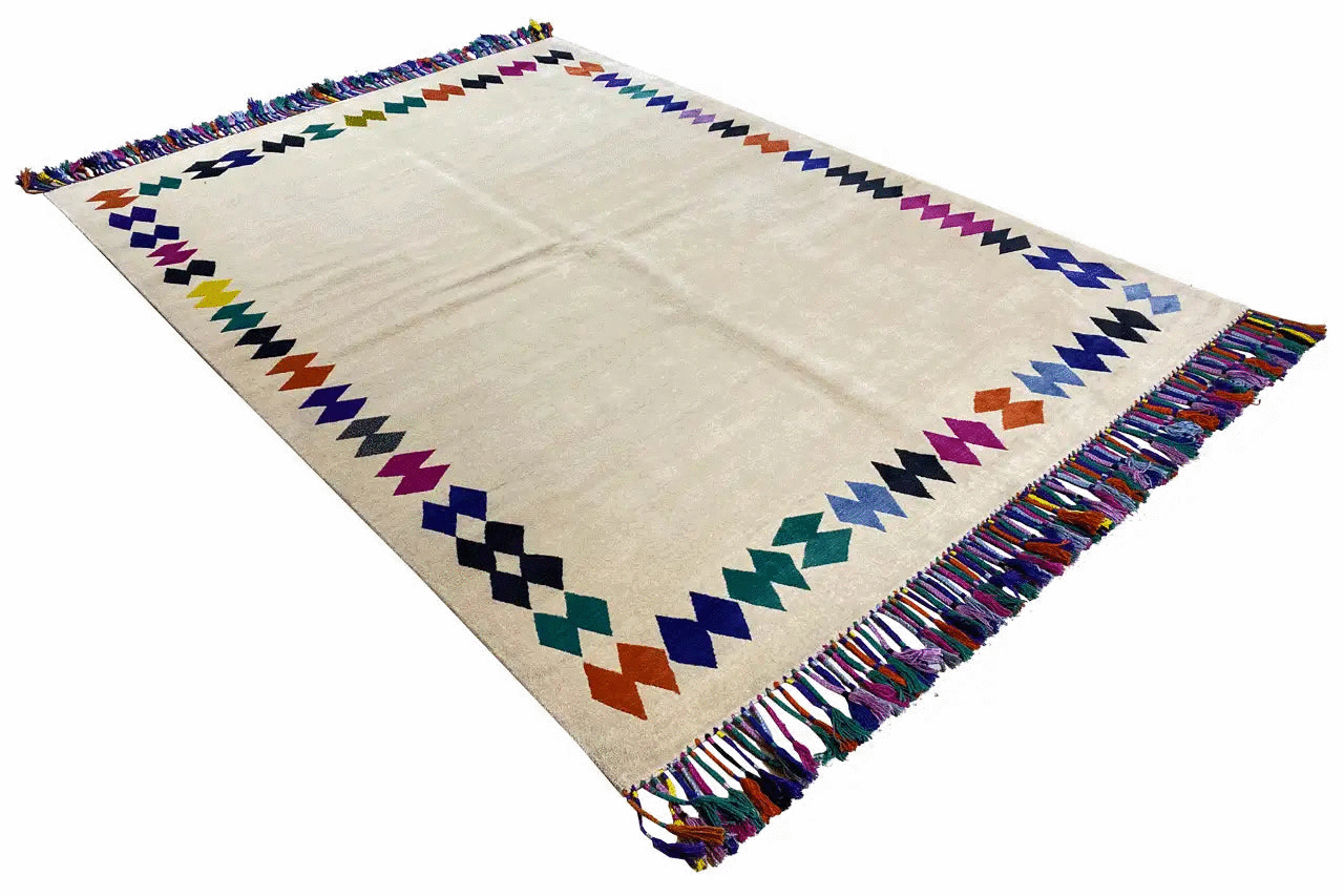 Rug with fringes, beige base, and geometric patterns with a zigzag border