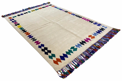 Rug with fringes, beige base, and geometric patterns with a zigzag border