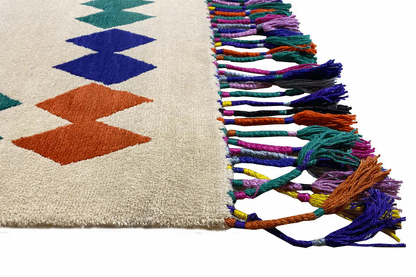 Rug corner with colorful fringe and two-tone zigzag patterns
