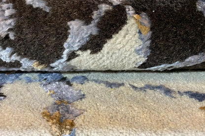 Designer rug with brown pile and abstract light-colored patterns