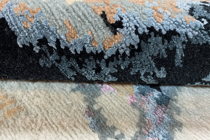 Designer rug close-up, blue-black pile with pattern and textured edge