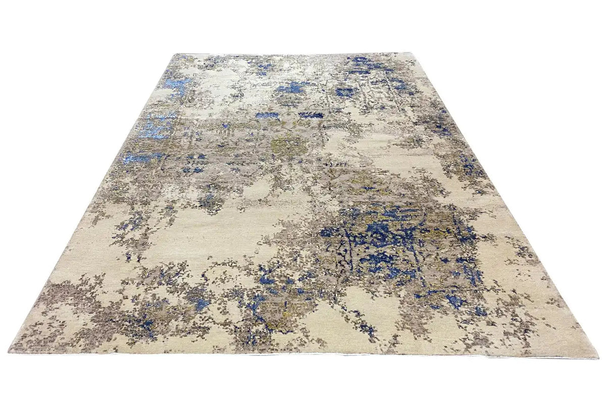 Rectangular rug with a beige background and a blue abstract block pattern