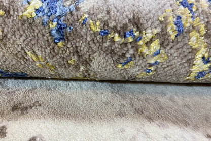 Carpet edge with a high-pile texture and blue pattern in detail