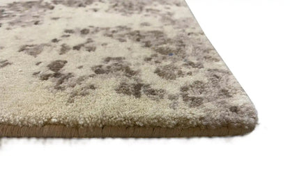 Corner view: beige carpet with blue-gray spots and a short pile