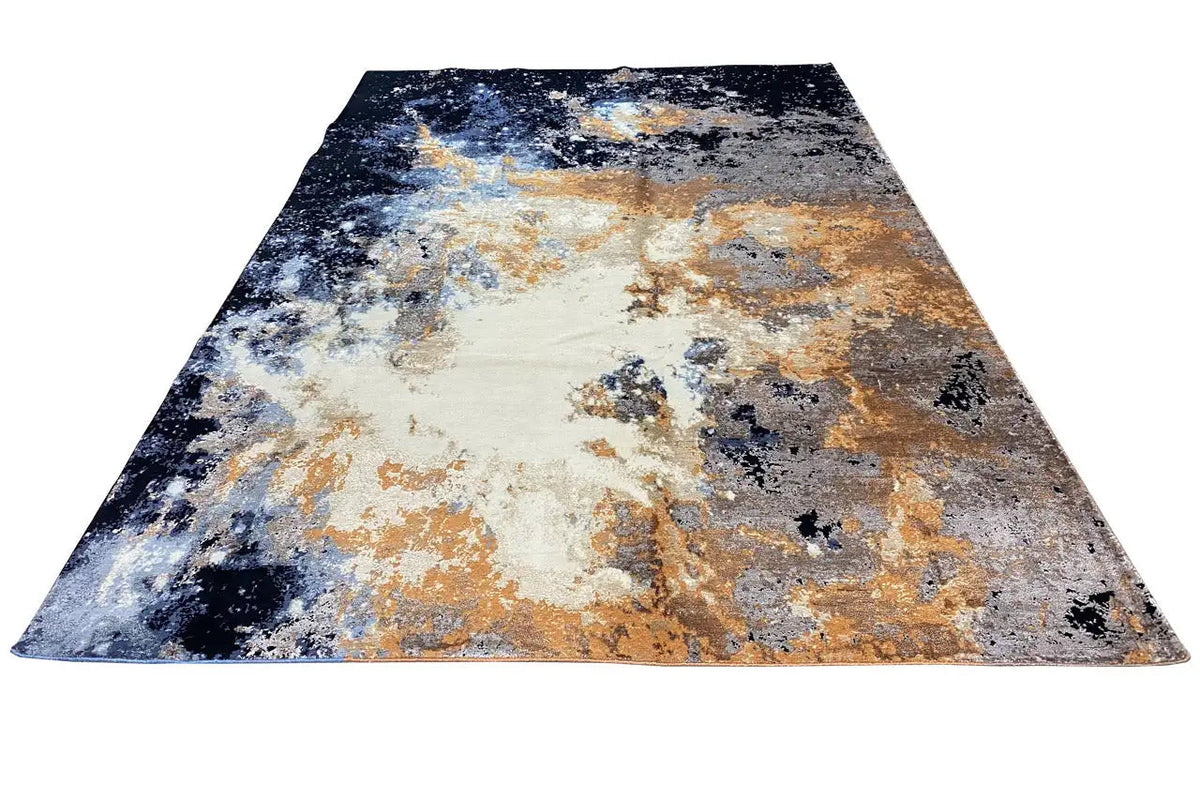 Rug with an abstract color gradient in dark blue, gray, beige, and ochre
