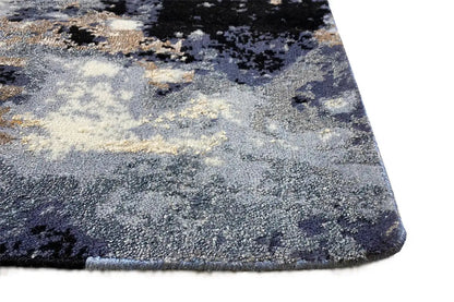 Rug view near the edge: abstract pattern in blue, gray, beige, and ochre