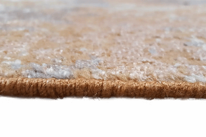 Carpet edge with dense pile in beige and brown tones, viewed from the side