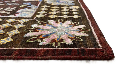Designer rug with a multicolored ornamental pattern and brown border, white hem
