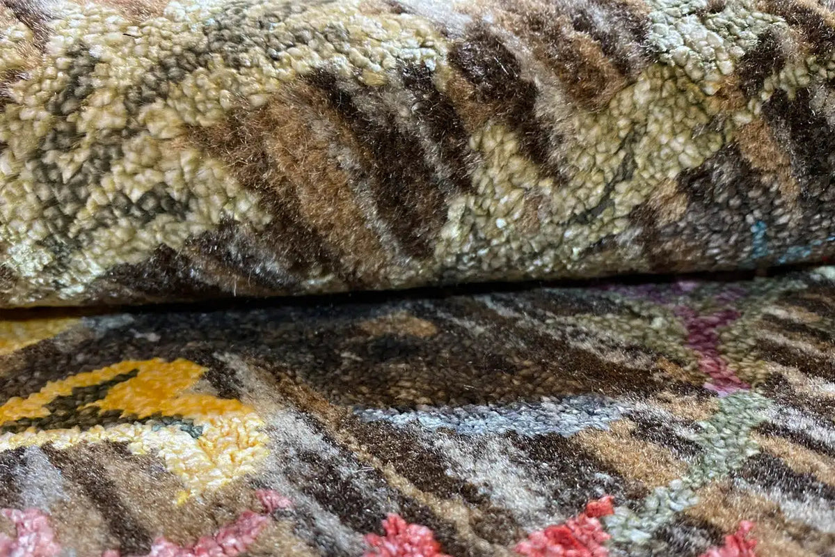Carpet detail: multicolored pile with floral motifs and a textured surface