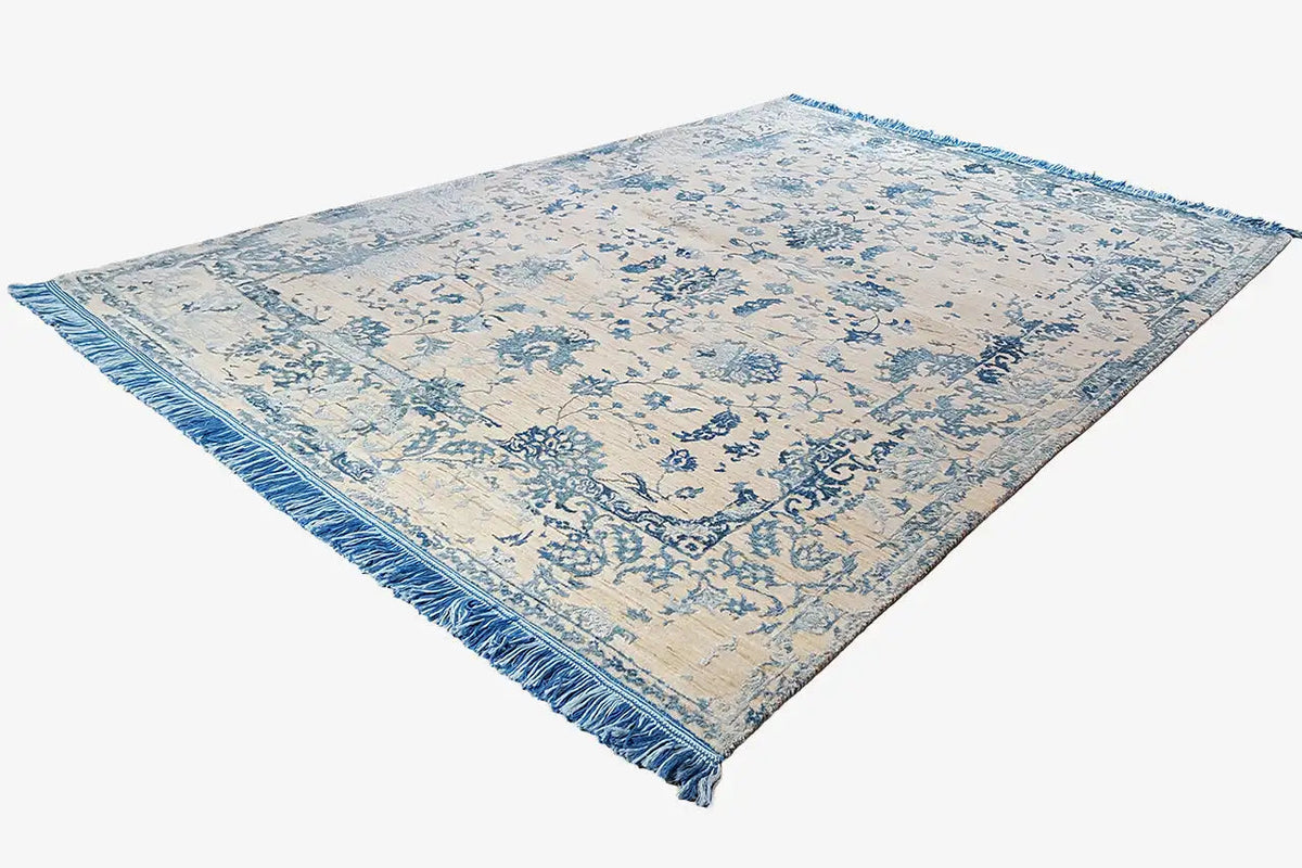 Designer rug with a blue floral pattern and fringe, rectangular