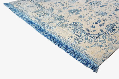 Designer rug, corner with a blue floral pattern and fringed border