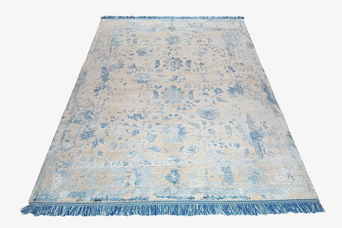 Rectangular designer rug with blue ornamental pattern and fringed edges