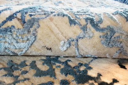 Carpet surface with blue ornament and beige accents, detailed texture