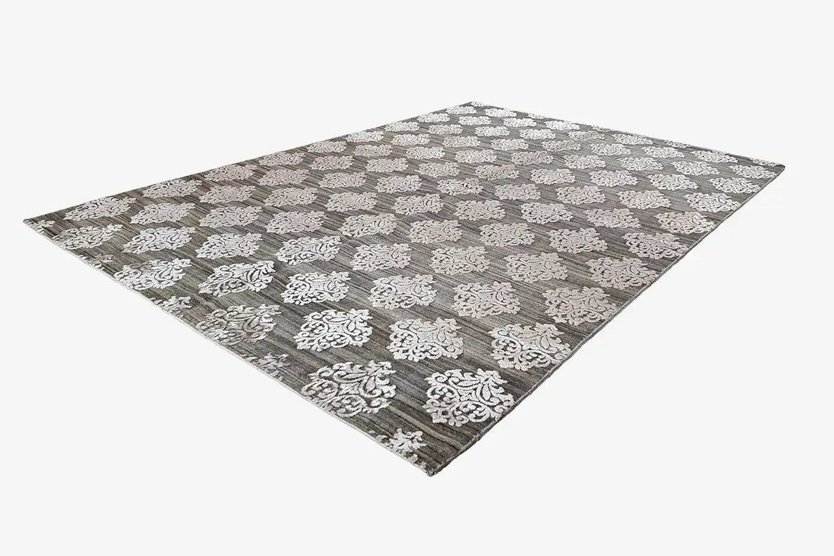 Designer rug with gray pile and a white ornamental pattern, rectangular view