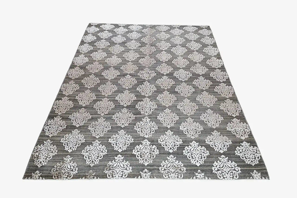 Designer rug with gray background and white damask ornament, flat view