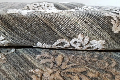 Carpet detail: gray pile with white ornaments and visible edge binding
