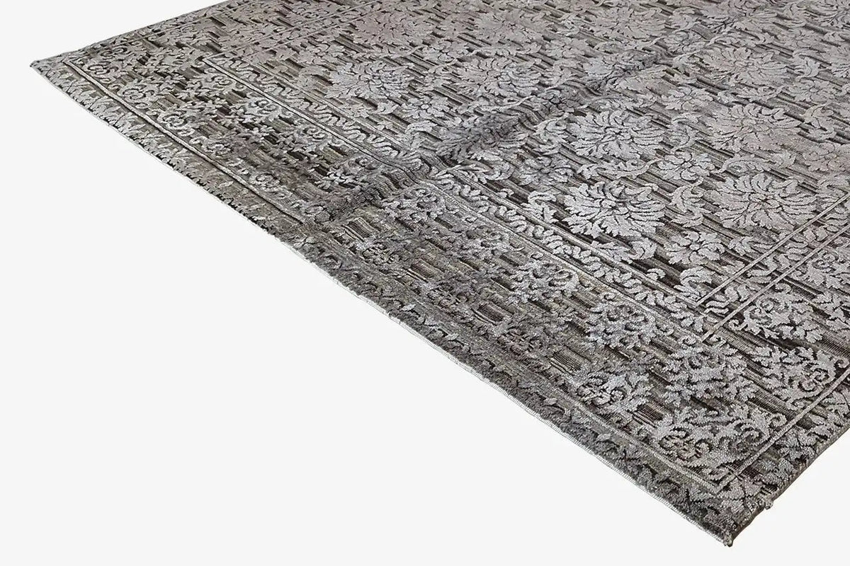 Rug with a dense vintage relief pattern in gray and dark gray, narrow border
