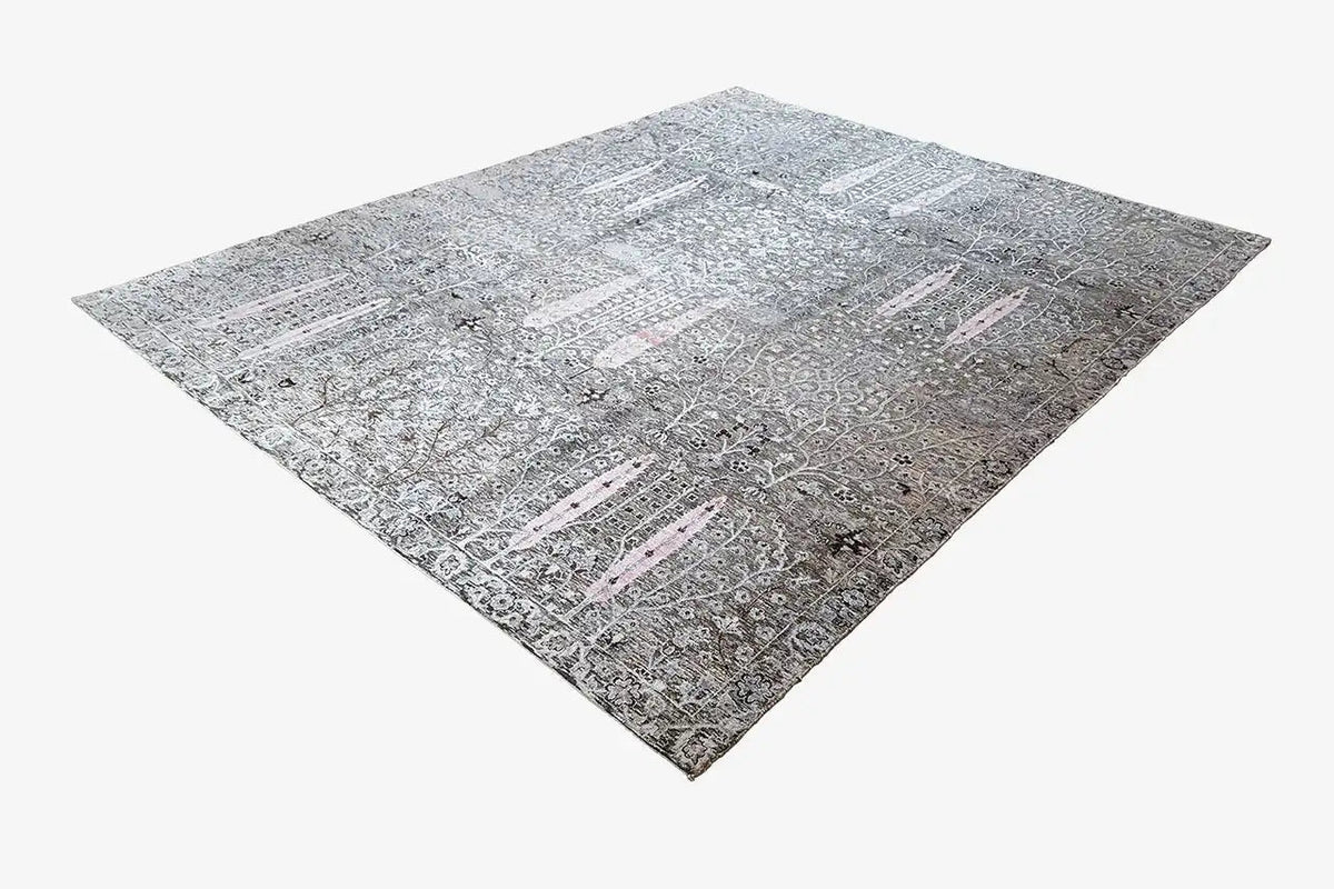 Designer rug with a light gray geometric pattern and delicate pink accents