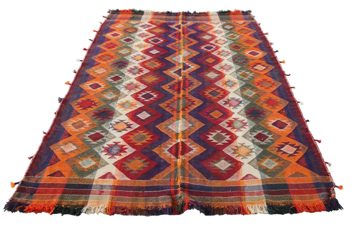 Colorful kilim rug with geometric patterns, fringes along the edges