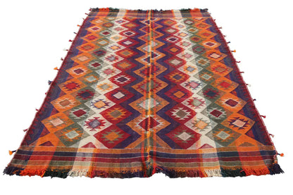 Colorful kilim rug with geometric patterns, fringes along the edges