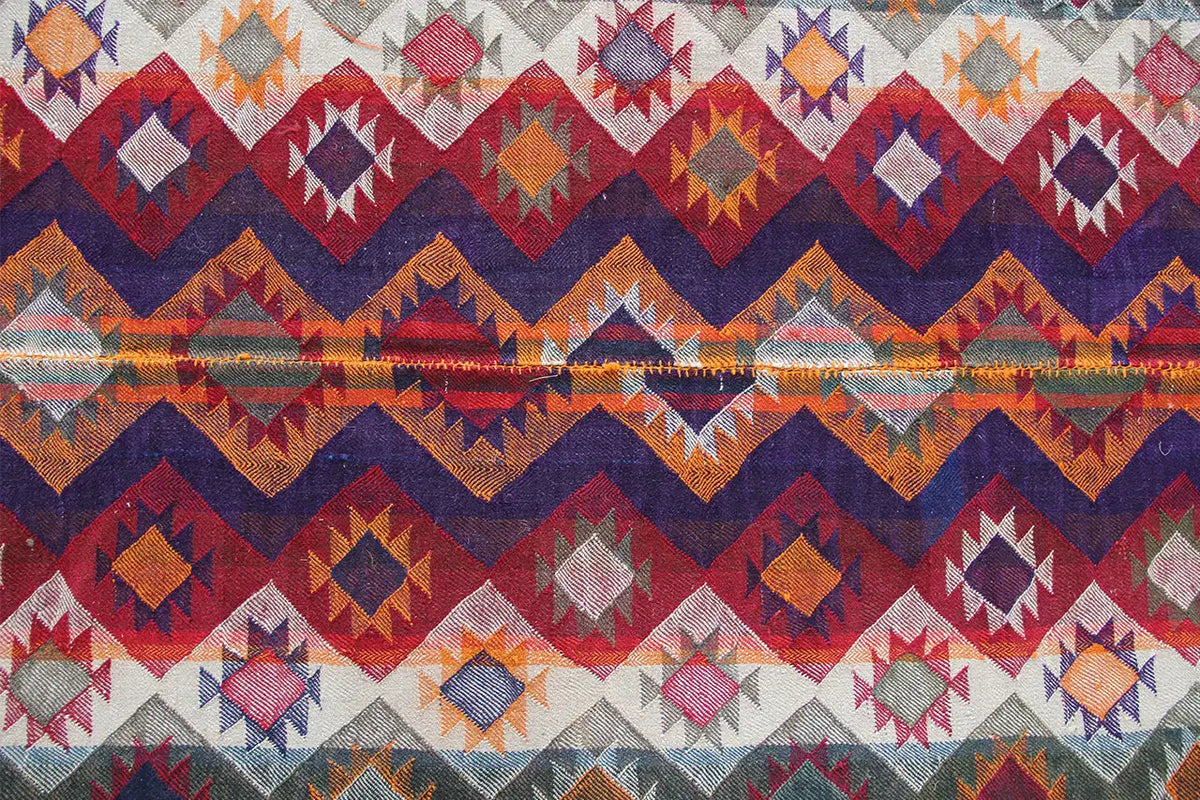 Full-surface pattern: many diamonds and zigzag lines in red, blue, orange, and gray