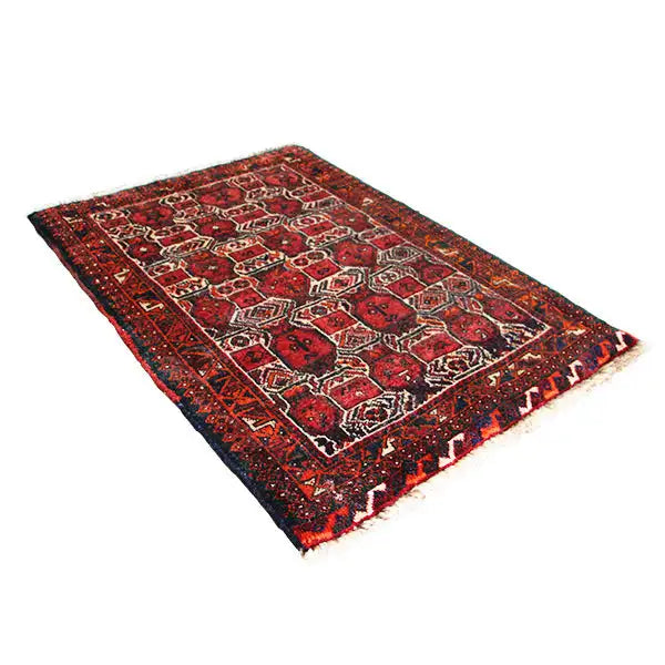 Oriental rug in burgundy with a geometric pattern and fringe along one edge