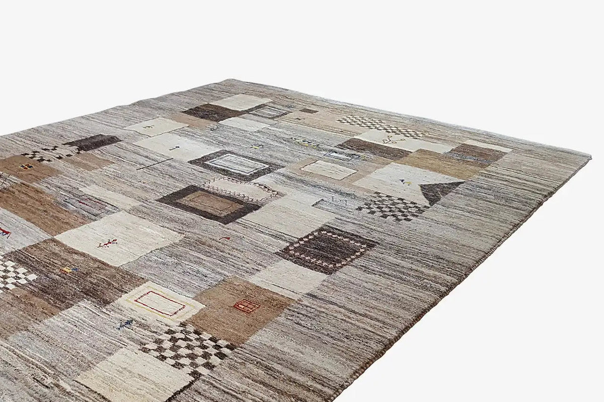Gabbeh rug with a geometric patchwork pattern in beige, gray, and brown