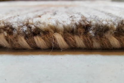 Gabbeh rug, edge view: dense pile with brown-beige fibers