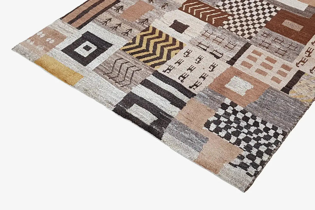 Rug with a dense patchwork pattern of rectangles and diamonds in beige, brown, and black