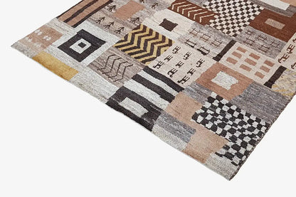 Rug with a dense patchwork pattern of rectangles and diamonds in beige, brown, and black