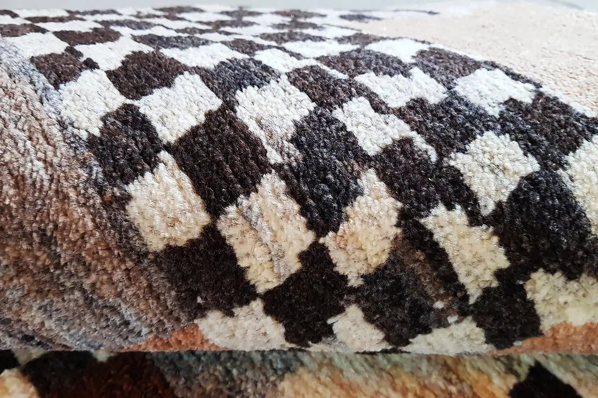 Close-up: rug with a rough pile texture and black-and-white and beige block patterns