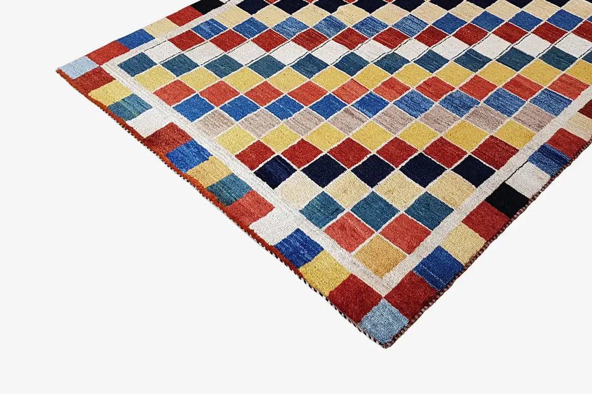 Gabbeh rug (196x132 cm) with a tile-like square pattern in blue, red, yellow, and black