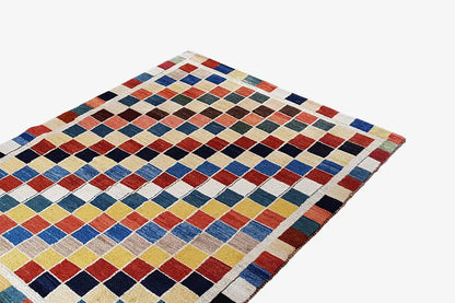 Gabbeh rug (196x132 cm) with a geometric diamond pattern in blue, red, beige, and black