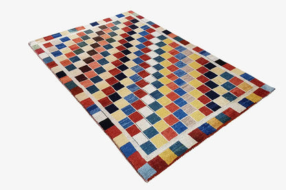 Gabbeh rug (196x132 cm) with a multicolored checked design and wool texture along the edges