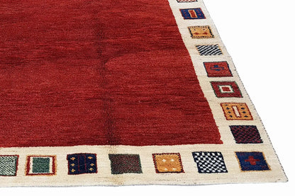 Rug with a red geometric field pattern and a beige border featuring small colorful squares