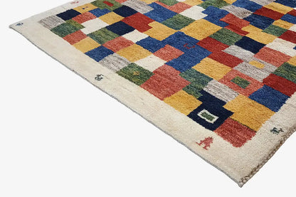 Gabbeh rug 203x147 cm in angled view, geometric patchwork of colorful squares