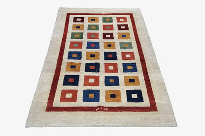 Gabbeh rug (203x129 cm) with a beige background, red border, and colorful square pattern