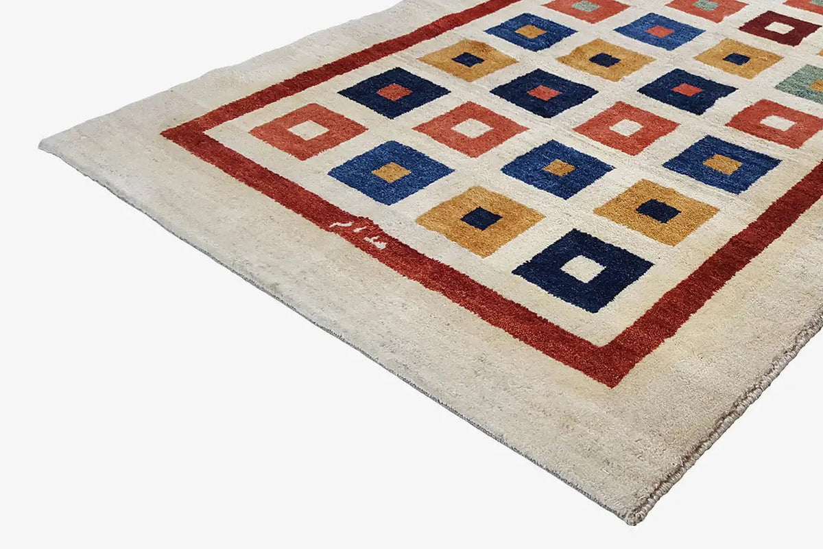 Gabbeh rug (203x129 cm) detail view: red border and multicolored diamond squares