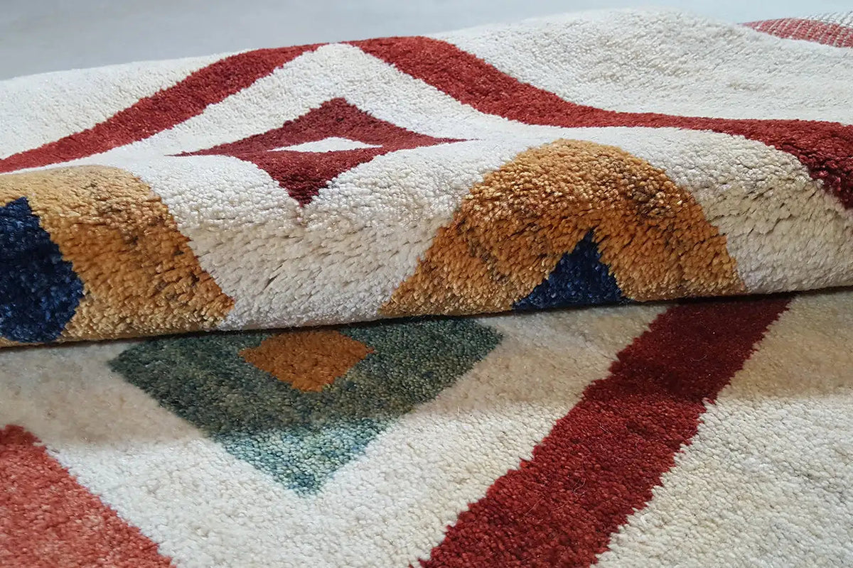 Gabbeh rug (203x129 cm) close-up: pile and pattern in red, blue, beige, and brown