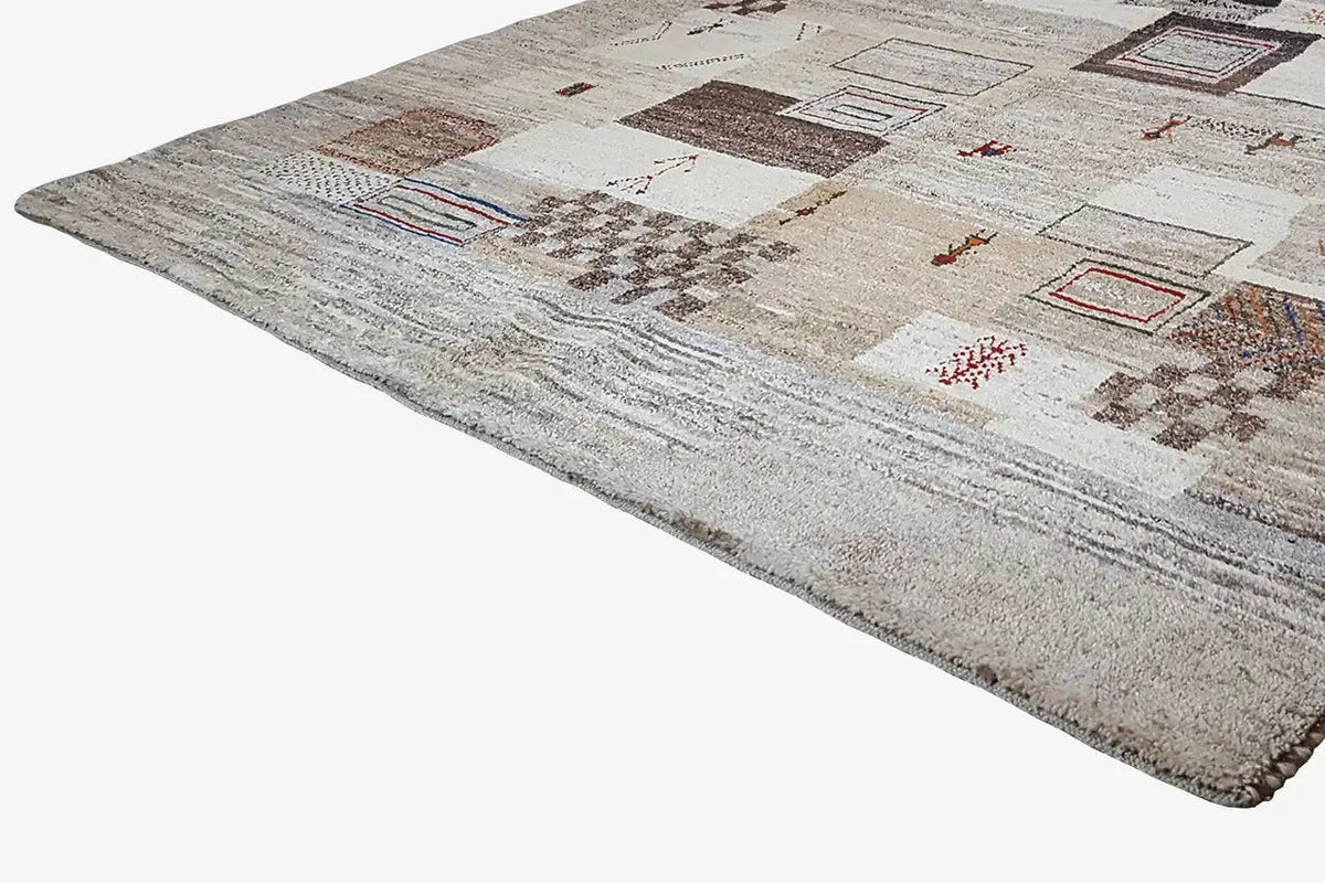 Gabbeh rug with a geometric patchwork design on a beige pile, 248x170 cm