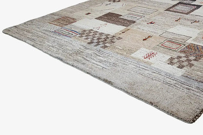 Gabbeh rug with a geometric patchwork design on a beige pile, 248x170 cm