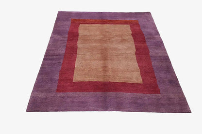 Gabbeh rug with a purple border and beige square, red inner border; rectangular, flat-woven.