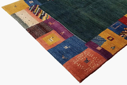 Gabbeh rug, dark green center, multicolored patchwork areas around the edges