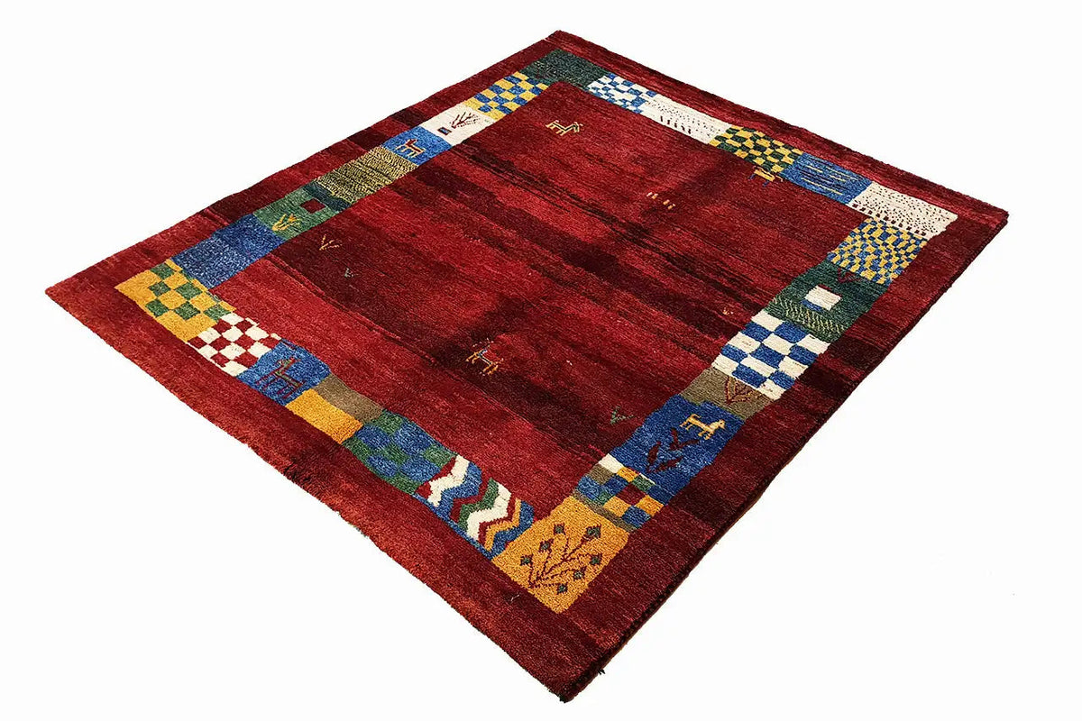 Gabbeh rug (176×145 cm) with a red all-over pattern and multicolored decorative border