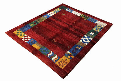 Gabbeh rug (176×145 cm) with a red all-over pattern and multicolored decorative border